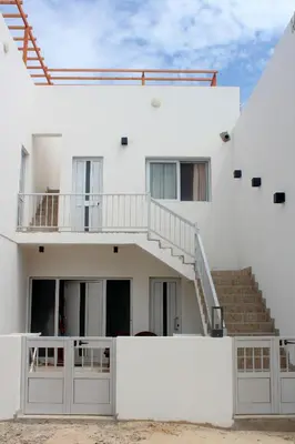 a white house with stairs and a stair case at My Boavista 2 in Sal Rei