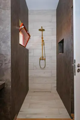 a bathroom with a shower with a shower head at Kasa Wahnon in Pombas