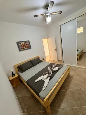 a large bed in a room with a ceiling fan at Nautilus Cabral Sea view, free Wi-Fi in Sal Rei