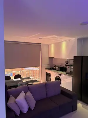 a living room with a couch and a kitchen at Alojamento Ribeirinha in Mindelo