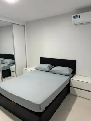a white bedroom with a large bed and mirrors at Alojamento Ribeirinha in Mindelo