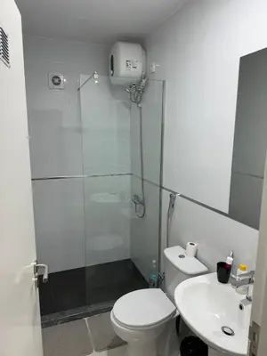 a bathroom with a shower and a toilet and a sink at Alojamento Ribeirinha in Mindelo