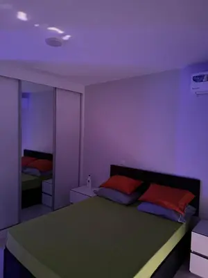 a bedroom with a large bed and a mirror at Alojamento Ribeirinha in Mindelo