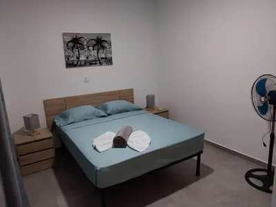 a bedroom with a bed with a hat on it at Tity Apartments T2 in Santa Maria