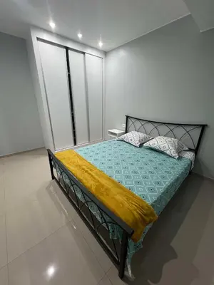 a bedroom with a bed with a yellow blanket on it at LAGINHA Apartamento in Mindelo