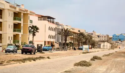 a street with cars parked on the side of a building at Turtle Apart in Sal Rei