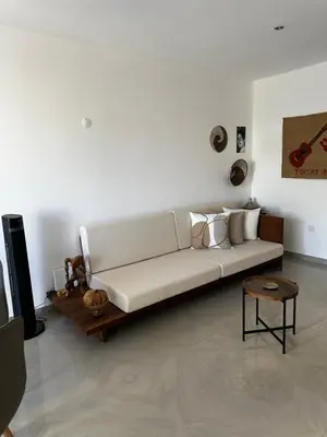 a white couch sitting in a living room at Fanon Flat T2 in Mindelo