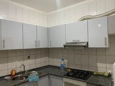 a kitchen with white cabinets and a sink at Tarrafal Paradise Suite in Tarrafal