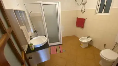 a bathroom with a shower and a sink and a toilet at Tarrafal Paradise Suite in Tarrafal