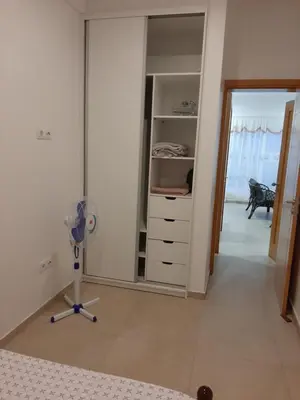 a room with a fan and a closet at Ap ACVA in Mindelo