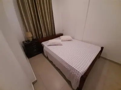 a small bedroom with a bed and a window at Ap ACVA in Mindelo