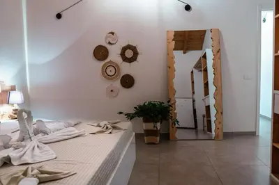a bedroom with a bed and a mirror at Tropical Suite 22 A in Santa Maria