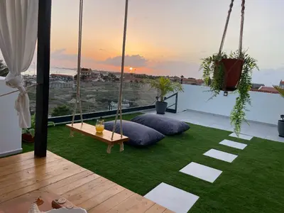 a living area with a hammock on a roof at Tropical Suite 22 B in Santa Maria