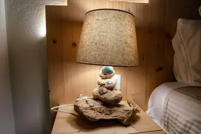 a lamp sitting on a table next to a bed at Tropical Suite 22 B in Santa Maria