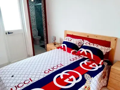 a bed with a coca cola blanket on it at Oásis de retour in Ponta do Sol