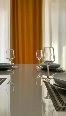two wine glasses sitting on top of a table at KANDAKE APARTMENT II Sal Rei Wi-fi in Sal Rei