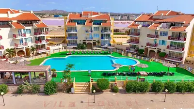 an aerial view of a apartment complex with a swimming pool at Suíte Salinas - Vila Cabral 2 in Sal Rei
