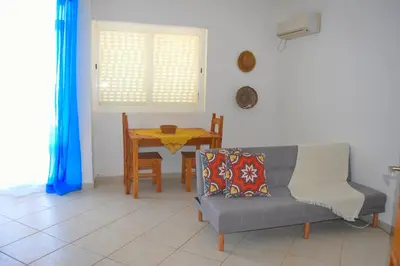 a living room with a couch and a table at Suíte Salinas - Vila Cabral 2 in Sal Rei