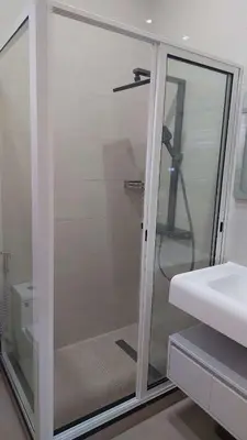a glass shower in a bathroom with a sink at Lily holiday hotel in Mindelo