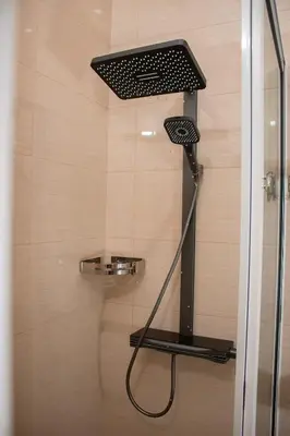 a shower with a shower head in a bathroom at Lily holiday hotel in Mindelo