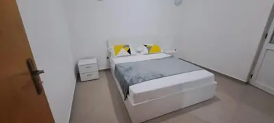 a white bedroom with a white bed with yellow pillows at Maravilha do Planalto in Assomada