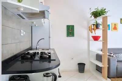 a kitchen with a sink and a stove top oven at Super Cozy One-Bedroom Apartment in Santa Maria