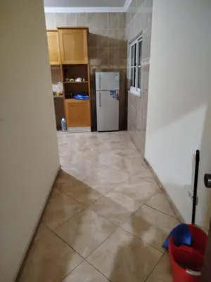 a hallway of a kitchen with a refrigerator at Apartamento espaçoso de 2 quartos amplos e mobilados in Praia