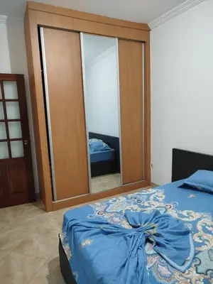 a bedroom with a bed and a large glass door at Apartamento espaçoso de 2 quartos amplos e mobilados in Praia