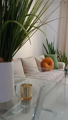 a living room with a couch and a glass table at Apartamento em Praia - Palmarejo in Praia