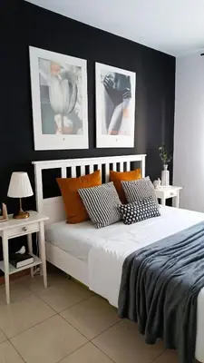 a bedroom with a white bed with three pictures on the wall at Apartamento em Praia - Palmarejo in Praia