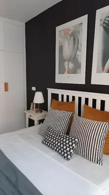 a bedroom with a white bed with two pillows at Apartamento em Praia - Palmarejo in Praia