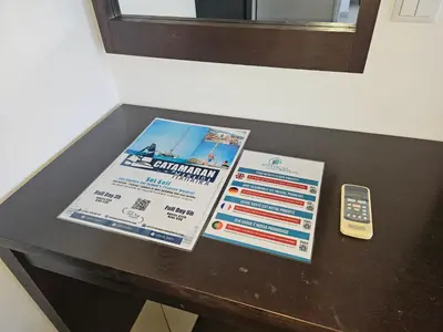 a table with a sign and a remote control at Privat Apartment with Pool View! in Santa Maria