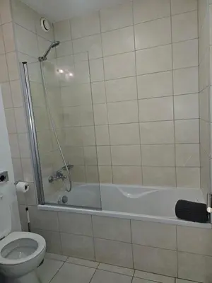 a bathroom with a shower and a toilet at Privat Apartment with Pool View! in Santa Maria