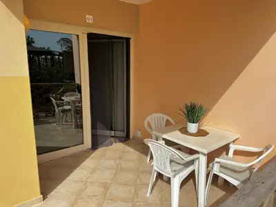 a table and chairs in a room with a patio at Tropical Pool View - By Bobbywashere in Santa Maria