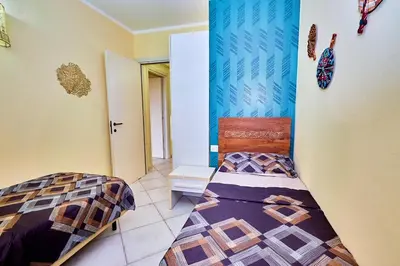 a bedroom with two beds in a room at Tropical African Vibe in Santa Maria