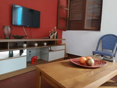 a room with a table with a plate of fruit on it at Mille Nuits Appartement in Tarrafal
