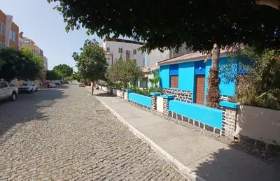 a blue and white building on the side of a street at Mille Nuits Appartement in Tarrafal