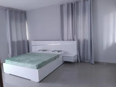 a white bedroom with a bed and a window at Assomada Comfort Ap in Assomada