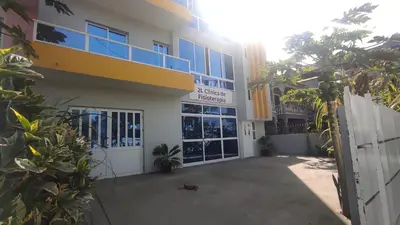 a building with a garage and a building with a gate at Cafofo in Tarrafal