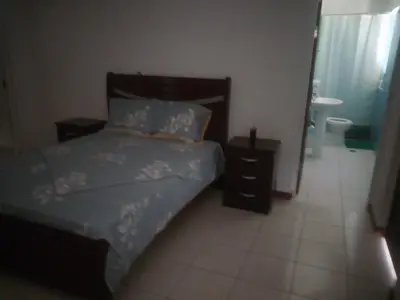 a bedroom with a bed and a bathroom at Bar Residencial Frontera in Mindelo