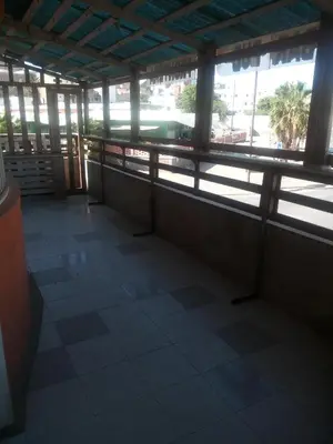 a room with a view of a pool in a building at Bar Residencial Frontera in Mindelo