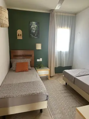 a bedroom with two beds and a window at Greenland Tropical in Santa Maria