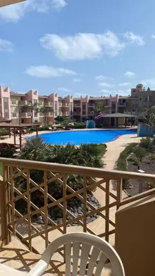 a balcony with a chair and a swimming pool at Greenland Tropical in Santa Maria
