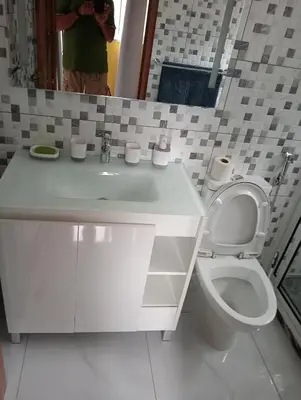 a bathroom with a white sink and a toilet at Bentub Home pousada in Ribeira Grande