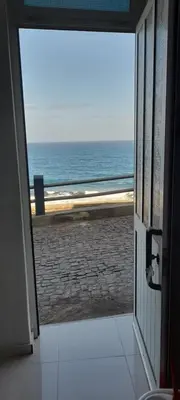 an open door to a view of the ocean at Santos Medina in Ribeira Grande