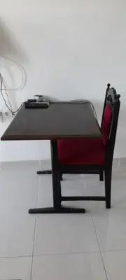 a ping pong table in a room with a red chair at Santos Medina in Ribeira Grande