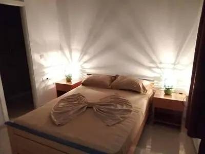 a bedroom with a bed with a bow tie on it at Santos Medina in Ribeira Grande