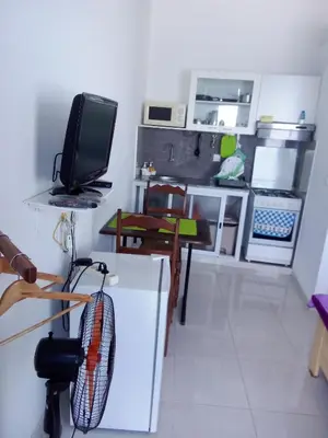 a small kitchen with a table and a tv in it at Santos Medina in Ribeira Grande