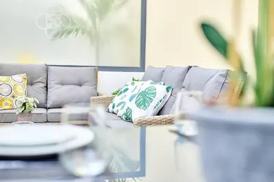 a living room with a gray couch with pillows at Apartamento Ap3 T1 Santa Maria Residence in Santa Maria