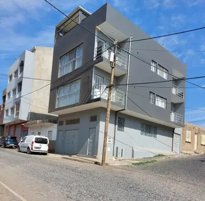 a white building on the side of a street at Studio Cruz Espia in Mindelo